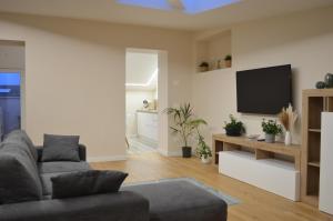 a living room with a couch and a flat screen tv at Palazzo del Principe in Castel di Sangro