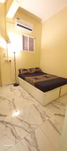 a bedroom with a bed and a marble floor at Quick home in Al Ain