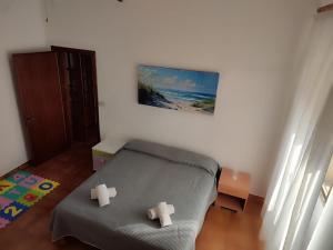a bedroom with a bed and a painting on the wall at Family & Friends - First floor - South West wing - Fully equipped with view - 15 minutes drive by car to the seaside in Galtellì