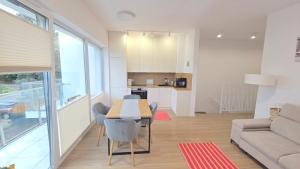 a kitchen and living room with a table and chairs at Apartament Słońce i Leżak in Przewłoka
