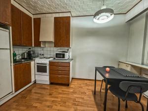 a small kitchen with a table and a microwave at bnbnord Outokumpu - Studio in Outokumpu