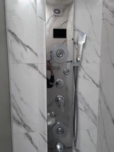 a shower with a glass door in a bathroom at Casa hasta 6 personas in Villa María +29 photos