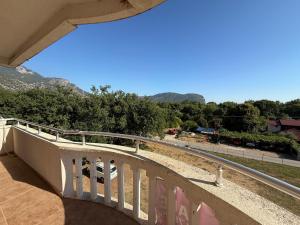 a balcony with a railing and a view of the mountains at Simple Stay in Buljarica