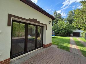 a large glass door on the side of a house at Tarnów Zawada Apartament in Tarnów