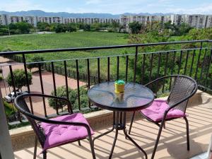 a table and two chairs with a cup on a balcony at AH/ Relax con vista natural, Peñalisa Ricaurte in Ricaurte