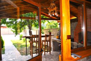 a screened in porch with a table and chairs at Къщи БРИК вила 2 in Sapareva Banya