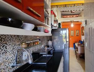 a kitchen with a sink and a refrigerator at Cantinho do Pequeno Arthur in Lençóis