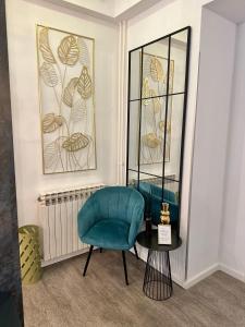 a room with two blue chairs and a mirror at Bed & Breakfast Donji Grad in Zagreb