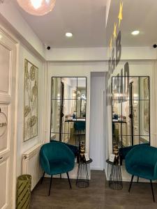 a room with two green chairs in a store at Bed & Breakfast Donji Grad in Zagreb
