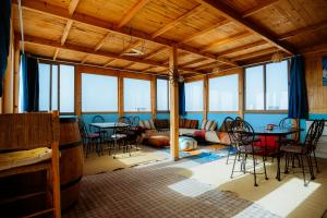 a room with tables and chairs and a couch at The Ocean Surf Villa in Dakhla