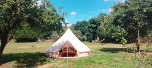 a white tent in the middle of a field at tente western in Le Pener