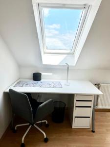 a white desk with a window and a chair at Wohnen auf dem Ponyhof in Laer +18 photos