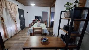 a living room with a table and chairs and a television at Alquiler Temporal Tandil - Xavier in Tandil +8 photos