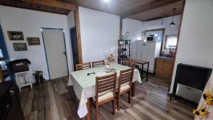 a kitchen and dining room with a table and chairs at Alquiler Temporal Tandil - Xavier in Tandil