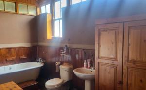 a bathroom with a tub and a toilet and a sink at The Journey GuestHouse in Ladybrand