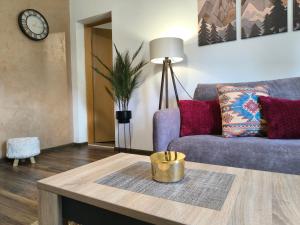 a living room with a couch and a table at Vukašinova stanica in Pale