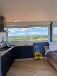 a small kitchen with a large window and a bed at Domaine du Petit Tournebelle in Gruissan +90 photos