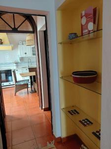 a room with a kitchen and a hallway with shelves at Villa Sesta in Vila de Frades