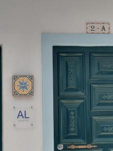 a green door and a sign on a wall at Villa Sesta in Vila de Frades