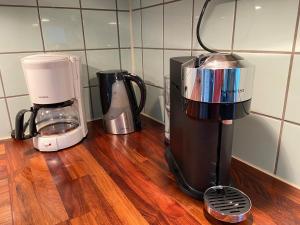a blender and a coffee maker on a wooden counter at Spacious and charming villa close Gothenburg in Kållered