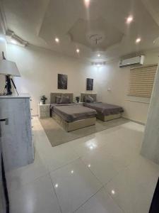 a large room with two beds and a couch at وحدات طيبة in Medina