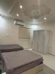 a bedroom with a bed and a air conditioner at وحدات طيبة in Medina