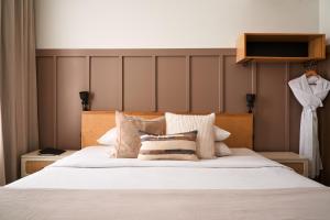 a bedroom with a large white bed with pillows at The Society Hotel in Portland