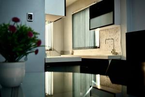 a bathroom with a sink and a vase with a plant at Cozy & Modern apartment in Arequipa!! in Arequipa +31 photos