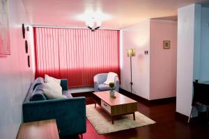a living room with a blue couch and a table at Cozy & Modern apartment in Arequipa!! in Arequipa