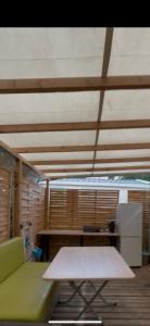 a room with a green couch and a table at Mobil home locazur83 in Fréjus