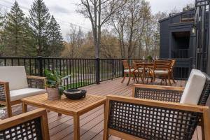a deck with chairs and a table and a tableablish at Michigan Mod Walk To Downtown in Saugatuck