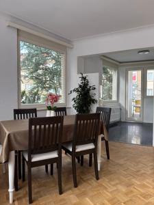 a dining room with a table and chairs and windows at Atomium Brussels Canopy in Brussels