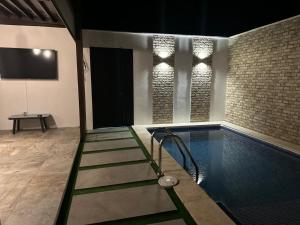 a house with a swimming pool with a tv at Casa Adriana in Río Dulce +1 photo