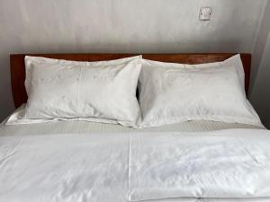 Postel nebo postele na pokoji v ubytování Risa Homes + 6 fotografií