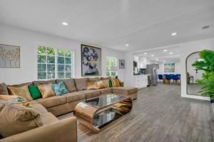 a living room with a couch and a table at La Pergola Villa 7 Br Poolhot Tub Location in Miami