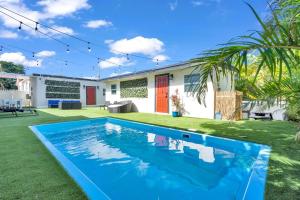 a swimming pool in the yard of a house at La Pergola Villa 7 Br Poolhot Tub Location in Miami