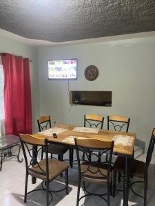 a dining room with a wooden table and chairs at The Chill Spot in Spring Garden