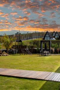 a park with a playground and a play structure at Cipó Chalés in Jaboticatubas