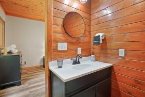 a bathroom with a sink and a wooden wall at Near Attractionsgame Roomsecludedgives Back! in Laurelville +56 photos
