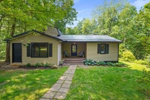 a yellow house with a porch and a lawn at Near Attractionsgame Roomsecludedgives Back! in Laurelville