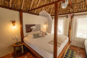 a bedroom with a bed in a room at Hotel Cielo y Selva in Punta Allen +87 photos