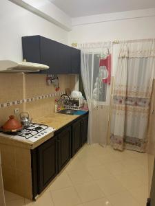 a kitchen with a stove and a counter top at Bel Appartement à louer à Fès in Fès +6 photos