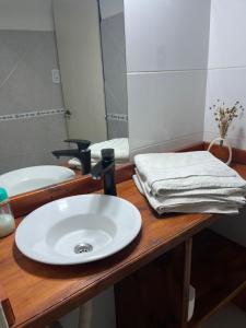 a bathroom counter with a sink and a mirror at Complejo Semaso in Santa Rosa +2 photos