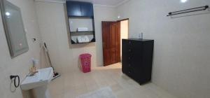 ein Badezimmer mit Waschbecken und schwarzem Schrank in der Unterkunft O'sena in Cotonou