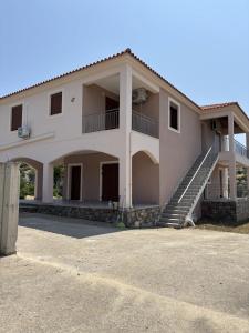 a large house with a staircase in front of it at Villa Amalia in Kriezá