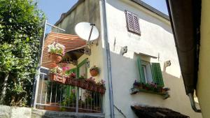 a building with potted plants on the side of it at Apartman Đurđica in Lovran