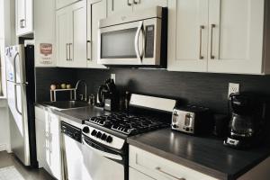 a kitchen with a stove and a microwave at Central Park north spacious residence in New York +7 photos