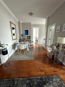 a living room with a table and a dining room at Central Park north spacious residence in New York