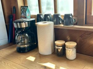 a kitchen counter with a coffee maker and a coffee pot at GlampCamp in Big Arm