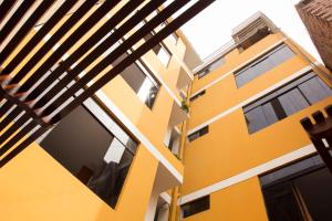 an exterior view of a yellow building at Hostal Las Fresas Lima Airport in Lima